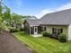 View of the rear exterior showing a screened in porch and manicured lawn at 422 Drake Ln, Salisbury, NC 28146