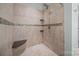 Tiled shower with built-in seat and mosaic accents at 422 Drake Ln, Salisbury, NC 28146