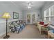 Bright sunroom with floral sofa, wicker chairs, neutral carpet, and access to the patio at 422 Drake Ln, Salisbury, NC 28146
