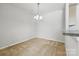 Dining room features neutral carpet, a modern light fixture, and a breakfast bar at 4226 Lotts Pl, Rock Hill, SC 29732