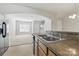 Open-concept kitchen features stainless appliances and views into the living room at 4226 Lotts Pl, Rock Hill, SC 29732