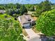 Aerial view of home showcasing a well-manicured lawn, mature trees, and a long driveway at 43041 Mimosa Ct, Fort Mill, SC 29707