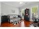 Cozy bedroom with hardwood floors, a daybed, a bookcase, and a rolling office chair at 43041 Mimosa Ct, Fort Mill, SC 29707