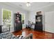 Bright bedroom featuring hardwood floors, a ceiling fan, and plenty of natural light from two windows at 43041 Mimosa Ct, Fort Mill, SC 29707
