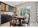Cozy dining area with a wooden table, upholstered chairs, and a stylish light fixture next to the kitchen at 43041 Mimosa Ct, Fort Mill, SC 29707