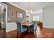 Elegant dining room featuring stylish wallpaper, hardwood floors, and modern lighting at 43041 Mimosa Ct, Fort Mill, SC 29707