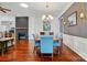 Dining area with a zebra painting, hardwood floors, and a modern chandelier at 43041 Mimosa Ct, Fort Mill, SC 29707