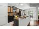 Modern kitchen with black cabinets, granite countertops, and stainless steel appliances at 43041 Mimosa Ct, Fort Mill, SC 29707