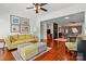 Inviting living room featuring hardwood floors, an elegant ceiling fan, and comfortable seating arrangements at 43041 Mimosa Ct, Fort Mill, SC 29707