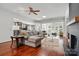 Spacious living room featuring hardwood floors, a ceiling fan, and an open floor plan at 43041 Mimosa Ct, Fort Mill, SC 29707