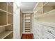 Large walk-in closet featuring custom shelves, drawers, and wood floors for maximum storage at 43041 Mimosa Ct, Fort Mill, SC 29707