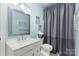 Well-lit bathroom featuring a vanity, toilet, and tub with a shower at 4406 Atkinson Way, Monroe, NC 28110
