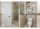 This bathroom features a tiled walk-in shower, a toilet, and display shelving at 4406 Atkinson Way, Monroe, NC 28110
