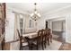 Dining room with a wooden table, upholstered chairs, and natural lighting at 4406 Atkinson Way, Monroe, NC 28110