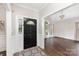 Inviting home entryway featuring elegant dark hardwood floors, decorative rug, and a stylish front door at 4406 Atkinson Way, Monroe, NC 28110