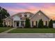 Charming brick home with a manicured lawn, complemented by beautiful landscaping and a welcoming facade at 4406 Atkinson Way, Monroe, NC 28110