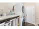 Functional laundry room featuring a washer, dryer, shelving, and storage baskets at 4406 Atkinson Way, Monroe, NC 28110