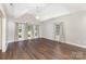 Bright and spacious living room featuring hardwood floors, vaulted ceilings, and large arched windows at 4406 Atkinson Way, Monroe, NC 28110