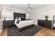 Bedroom with a dark bed, dark dressers and modern chandelier at 4406 Atkinson Way, Monroe, NC 28110