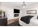 Main bedroom with a TV and a fireplace, hardwood floors, and neutral walls at 4406 Atkinson Way, Monroe, NC 28110