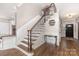 Elegant staircase with decorative railing, wood steps, and paneled walls leading to the upper level at 4406 Atkinson Way, Monroe, NC 28110