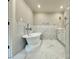 Elegant bathroom with a standalone tub, sleek fixtures, and marble tile throughout at 456 Brook Valley Ne Ct, Concord, NC 28025