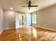 Bedroom showcasing hardwood floors, ceiling fan, and ensuite bathroom at 456 Brook Valley Ne Ct, Concord, NC 28025