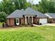 Attractive brick home with green lawn, a well-maintained landscape, and a convenient two-car garage at 456 Brook Valley Ne Ct, Concord, NC 28025