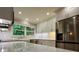 Updated kitchen with stainless steel appliances, white cabinets, quartz countertops, designer finishes, and lots of light at 456 Brook Valley Ne Ct, Concord, NC 28025