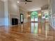 Spacious living room boasts hardwood floors, fireplace, open layout, and abundant natural light with view of updated kitchen at 456 Brook Valley Ne Ct, Concord, NC 28025