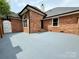 Spacious patio area with brick accents, perfect for outdoor entertaining and relaxation at 456 Brook Valley Ne Ct, Concord, NC 28025