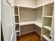 Walk-in closet with custom shelving and hardwood floors for ample storage space at 456 Brook Valley Ne Ct, Concord, NC 28025