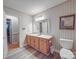 Traditional-style bathroom featuring a single sink vanity, a toilet, and a mirrored wall at 4620 Binwhe Ln, Gastonia, NC 28052