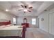 Spacious bedroom featuring a tray ceiling, ceiling fan, and natural light from two windows at 4620 Binwhe Ln, Gastonia, NC 28052
