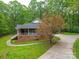 Charming brick home with a screened-in porch, complemented by lush greenery and a well-maintained driveway at 4620 Binwhe Ln, Gastonia, NC 28052