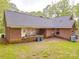 Back side of a single-story brick home with large lawn and back patio at 4620 Binwhe Ln, Gastonia, NC 28052