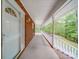 Inviting front porch with a white railing, offering a serene outdoor space with views of the surrounding landscape at 4620 Binwhe Ln, Gastonia, NC 28052