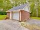 Brick detached garage with two garage doors and a side door at 4620 Binwhe Ln, Gastonia, NC 28052