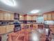 Bright kitchen featuring wood cabinets, stainless steel appliances, and a corner sink at 4620 Binwhe Ln, Gastonia, NC 28052