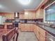 Bright kitchen featuring wood cabinets, stainless steel appliances, and a corner sink at 4620 Binwhe Ln, Gastonia, NC 28052