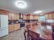 Bright kitchen with stainless steel appliances, wood cabinets, and an oversized wooden dining table at 4620 Binwhe Ln, Gastonia, NC 28052
