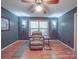 Comfortable room with a recliner, side table, hardwood floors, and natural light from a window at 4620 Binwhe Ln, Gastonia, NC 28052