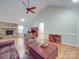 Bright living room featuring hardwood floors, vaulted ceilings, a stone fireplace, and comfortable seating arrangement at 4620 Binwhe Ln, Gastonia, NC 28052