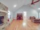 Bright living room featuring hardwood floors, vaulted ceilings, a stone fireplace, and a dedicated office nook at 4620 Binwhe Ln, Gastonia, NC 28052