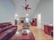 Bright living room featuring hardwood floors, vaulted ceilings, a stone fireplace, and comfortable seating arrangement at 4620 Binwhe Ln, Gastonia, NC 28052