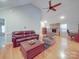 Open-concept living room featuring hardwood floors, vaulted ceilings, a stone fireplace, and comfortable seating at 4620 Binwhe Ln, Gastonia, NC 28052