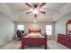 Spacious primary bedroom featuring trey ceiling, plush carpet, two windows, and a ceiling fan at 4620 Binwhe Ln, Gastonia, NC 28052