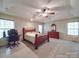 Spacious primary bedroom featuring trey ceiling, plush carpet, two windows, and a ceiling fan at 4620 Binwhe Ln, Gastonia, NC 28052