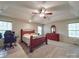 Spacious primary bedroom featuring trey ceiling, plush carpet, two windows, and a ceiling fan at 4620 Binwhe Ln, Gastonia, NC 28052