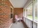 Cozy screened-in porch featuring a chair and table, perfect for relaxing and enjoying the outdoor scenery at 4620 Binwhe Ln, Gastonia, NC 28052
